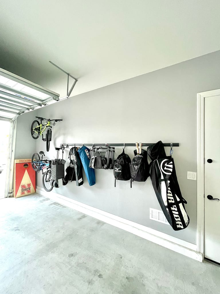 An organized garage using the fast rack system from rubbermaid