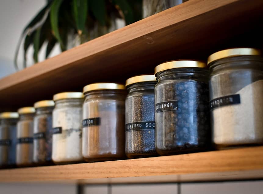 Jars organized in a pantry on a shelf